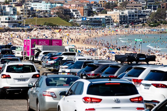 People enjoying the long weekend at Bondi Beach, the carpark busy but not closed.