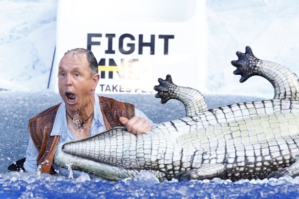 Terry Daniher, former Essendon great and brother of Neale Daniher, goes down the slide as Crocodile Dundee for Big Fight MND Freeze 8, at the MCG . 