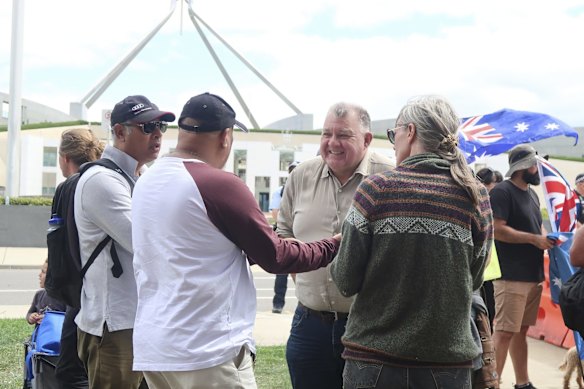 Politician Craig Kelly speaks with people at the Convoy to Canberra protest in front of Parliament House.