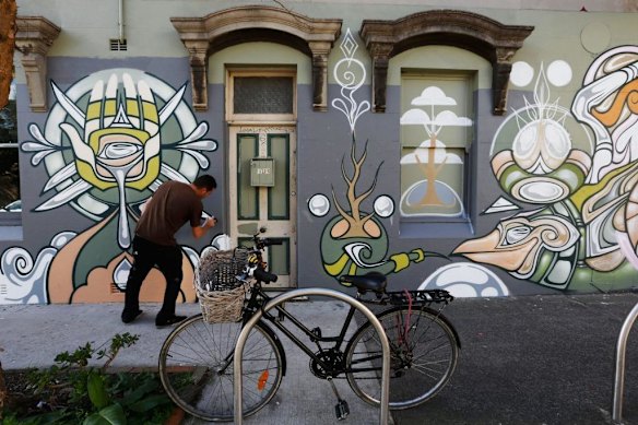 Tim Phibs works on his artwork on the walls of Alfalfa House in Newtown.