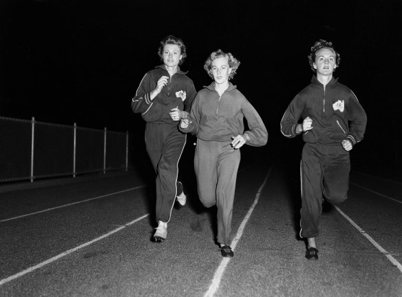 Marlene Mathews, left, trains with Kay Johnson and Gloria Cooke at the E.S. Marks Athletics field in Sydney’s Kensington on March 25, 1958.