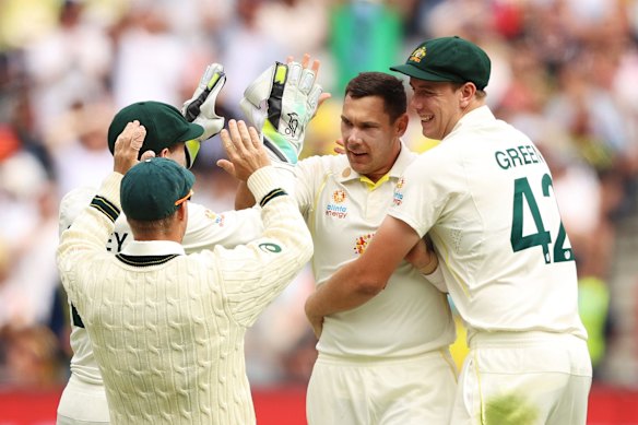 Scott Boland of Australia celebrates with teammates after taking his first test wicket.