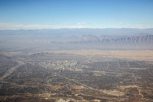 Buildings stand in front of mountain ranges at Kashgar, Xinjiang autonomous region in China.