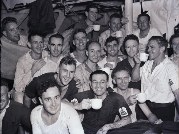Members of the crew of the HMAS Sydney, Dick Curtis [back left with cup], Otto Smith [right with cup] and George Berry [front with white T-shirt], upon their arrival at Circular Quay in Sydney, 10 February 1941.
SMH Picture by FJ HALMARICK