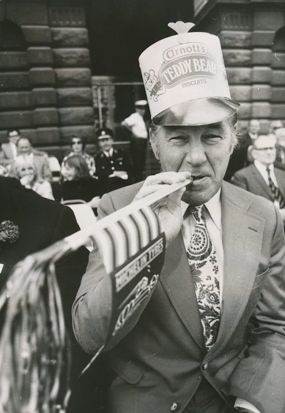 Victoria's Premier Dick Hamer - complete with Teddy Bear biscuits hat and a toy whistle - was one of the side attractions of Melbourne's 21st Moomba parade, 1975.