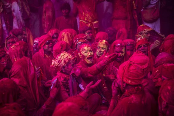 Hindu devotees play with colour during Lathmaar Holi celebrations in the village of Barsana, India.