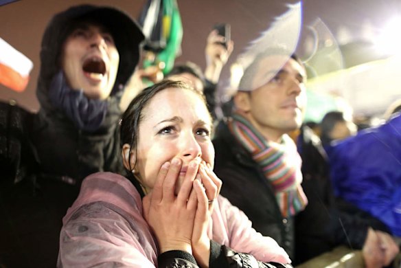 People jubilate as white smoke rises from the chimney on the roof of the Sistine Chapel.