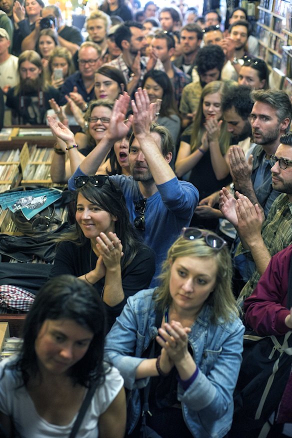 People applaud as Paul Kelly performs with Vika and Linda at Greville Records as part of World Record Day celebrations on April 18, 2015 in Melbourne, Australia.  