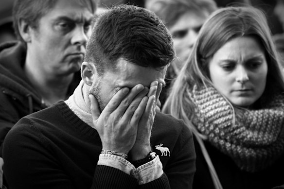 Faces of Paris. Parisians silently paid respect to the 129 people killed in the terror attack in Paris across many memorial sites including Le Carillon bar.