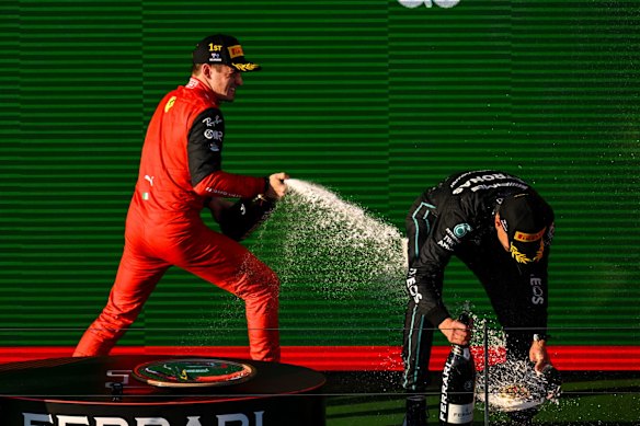 Charles Leclerc and George Russell celebrate on the podium.