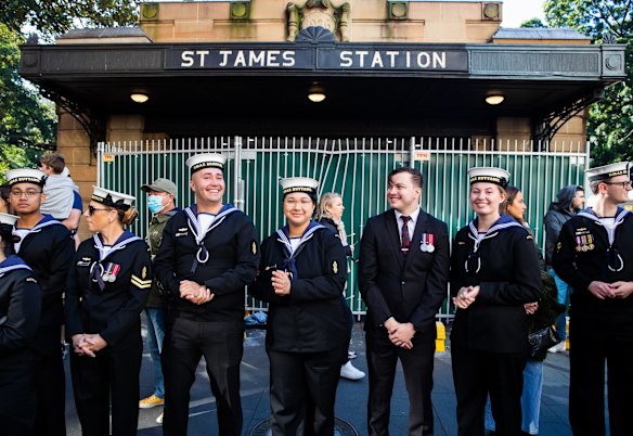 Spectators watch the ANZAC Day march down Elizabeth St, Sydney.