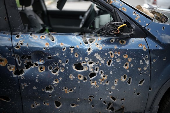 What appears to be shrapnel holes cover a vehicle destroyed by the war. It is among hundreds of cars  in a car park that has been dubbed the "car cemetery" by locals in Irpin. As Russia concentrates its attack on the east and south of the country, residents of the Kyiv region are returning to assess the toll on their communities.