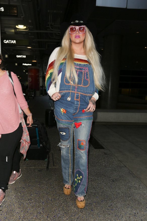 Over the rainbow ... Kesha wearing a pair of colourful, customised overalls at LAX.