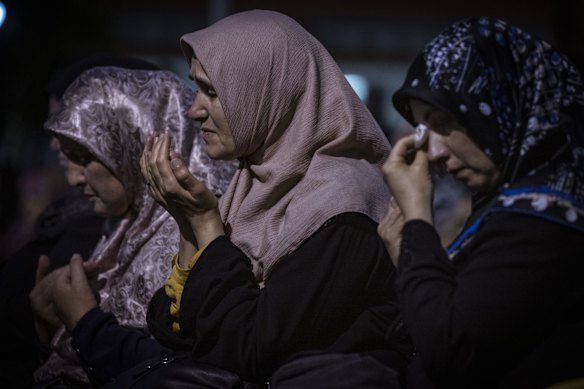Women are overcome with emotion at a vigil for those who have died in the earthquake in Turkey and Syria.