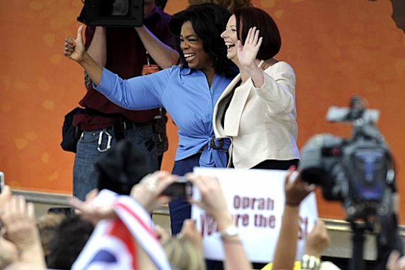 Oprah on stage with Prime Minister Julia Gillard.