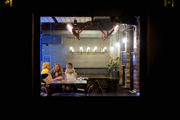 (L-R) Tess Fisher, Carla Snellen  and Steph Parsons  enjoying a a drink at The Local Hotel in Port Melbourne after midnight.