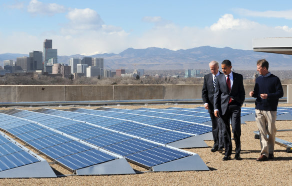 Picking up where Barack Obama left off: Joe Biden (left) visits rooftop solar panels in Denver, Colorado in 2009, when he was US Vice-President.