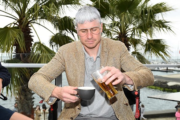 Mitch Duncan pours a beer into a tea cup