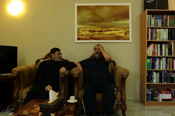 Khalid Mishal (right) has a cup of coffee with a friend at his friend's home in Doha, Qatar.