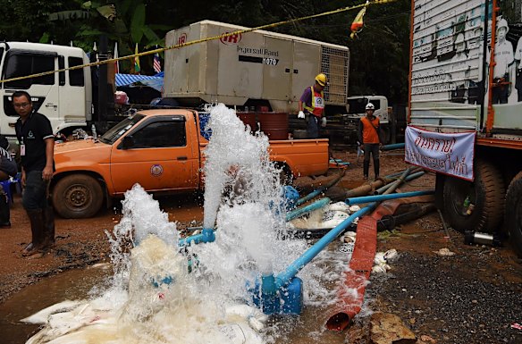 Men from the Electricity Generating Authority of Thailand overseeing the pumping of water from Tham Luang Cave.