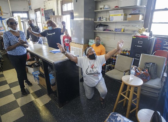 Gail Russell, 68, falls to her knees and proclaims "Thank you Jesus" at Gloria's Corner Store in New Orleans, as she listens to judge Peter Cahill read the three verdicts, after a jury found former Minneapolis police officer Derek Chauvin guilty of all counts in the death of George Floyd.