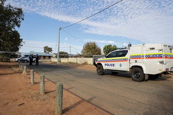 Police officers stand on patrol outside a house where four-year-old Cleo Smith was found.