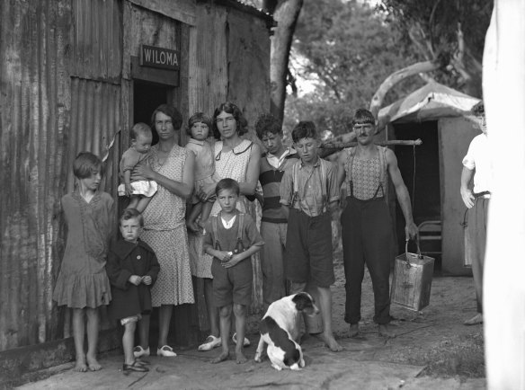 A family in front of their house for the unemployed at Cook Park, Brighton-le-Sands, Sydney, circa 1934. 