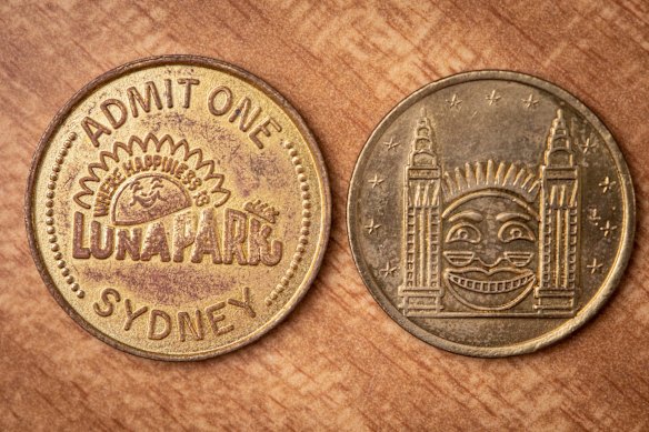 "Post-1969, as they have the logo where happiness is like the tea towel 1970-1979. It was before the ghost train fire," says Nicole Brett with her Luna Park collection at her Brisbane home. Photo: Paul Harris