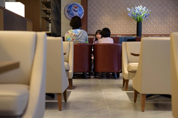 A woman and her daughters relax in the View Gold Lounge, operated by East Japan Railway Company and View Card, at Tokyo Station in Tokyo, Japan. Passengers on the GranClass can check into this lounge at Tokyo Station before boarding.