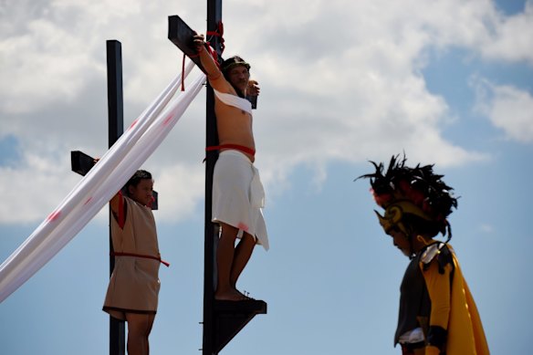 Reuben Enaje (right cross) playing the role of Jesus during the Passion Play a re-enactment of Christs crucifixion, on Good Friday.