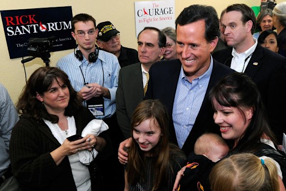 Rick Santorum poses for photos at an election results party.
