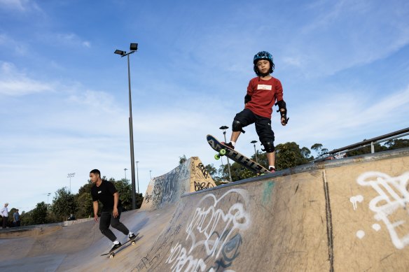 Eight-year-old Dinn works on his skateboarding skills at Sydney Park skate park.