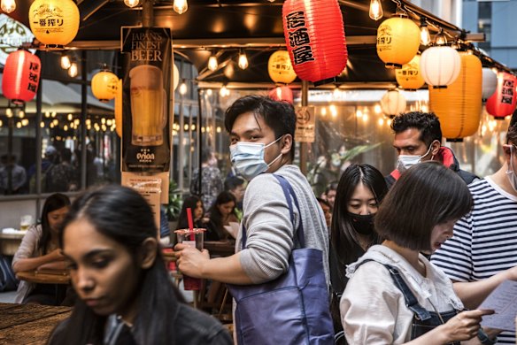 People bustle in a new area of Chinatown, Sydney.