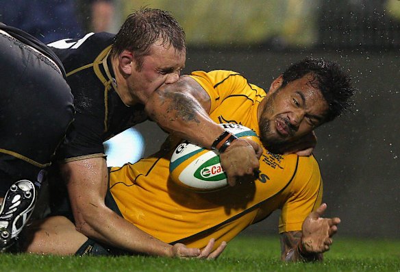 Digby Ioane of Australia is tackled by Richie Gray of Scotland during the International Test match between the Australian Wallabies and Scotland at Hunter Stadium on June 5, 2012 in Newcastle, Australia.