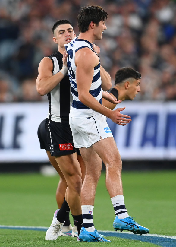 Brayden Maynard of the Magpies pushes Oliver Henry of the Cats.