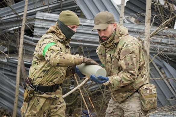 Ukrainian interior ministry sappers collect unexploded shells, grenades and other devices in Hostomel.