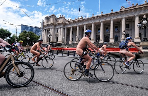 Cyclists ride past Parliament during the World Naked Bike Ride in Melbourne.
