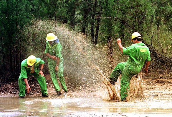 Firefighters Rodney Robson splashing Myles Huggett and Dennis Ellis near Coonabarabran in January 1997. 

