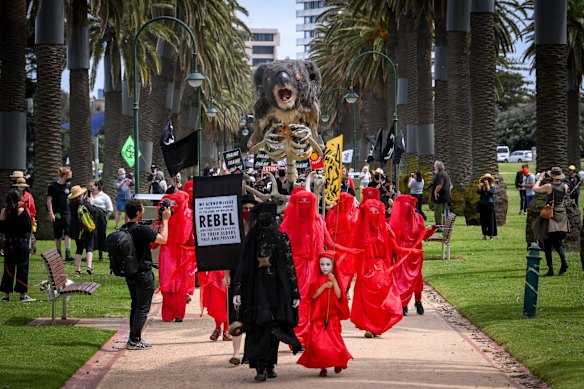 The sombre Extinction Rebellion procession through Catani Gardens was accompanied by a group of musicians playing Chopin’s Funeral March. The group’s signature, silent ‘Red Rebels’ - wearing flowing red dresses and white face paint - lead the protest of more than 100 people.