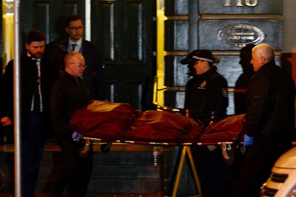 A body being removed late Tuesday night from a building on Clarence Street.