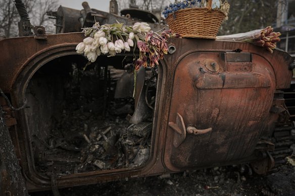 Flowers lay on a Ukrainian military armoured fighting vehicle, destroyed during fighting on the outskirts of Kyiv.
