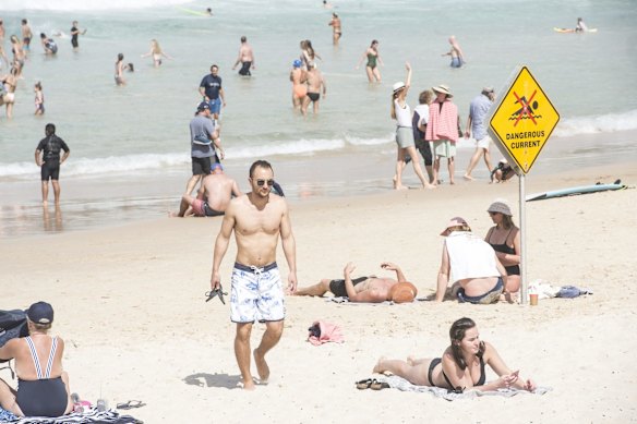 Bondi Beach saw fewer visitors than Friday, but still a large turn out despite social isolation measures.