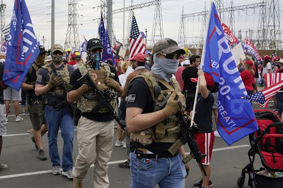 Supporters of President Donald Trump rally outside the Maricopa County Recorder's Office in Phoenix. 