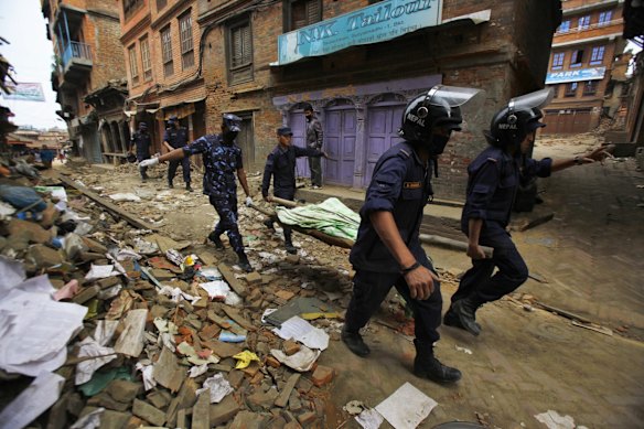 Nepalese rescue team carry on a stretcher the body of a victim recovered from the debris of a building that collapsed after an earthquake inBhaktapur, near Kathmandu, Nepal, Sunday, April 26, 2015. 