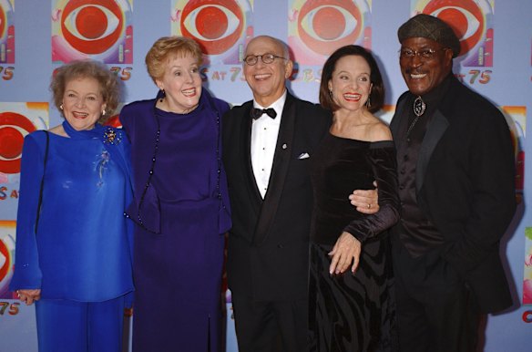 In this Nov. 2, 2003 file photo, actors Betty White, left, Georgia Engel, second left, Gavin MacLeod, center, Valerie Harper, second right, and John Amos pose for photographers during arrivals at CBS's 75th anniversary celebration in New York.   