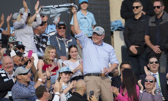Newly re-elected Prime Minister Scott Morrison waves to the crowd during the NRL match between the Cronulla Sharks and the Manly Sea Eagles.