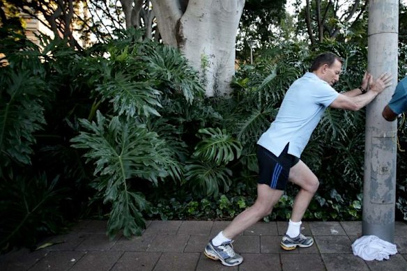 City 2 Surf: Opposition Leader Tony Abbott stretches ahead of the race.