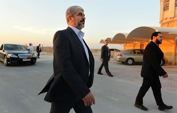 Khalid Mishal (3rd from right) walks with his security in the suburban streets of Doha, Qatar.