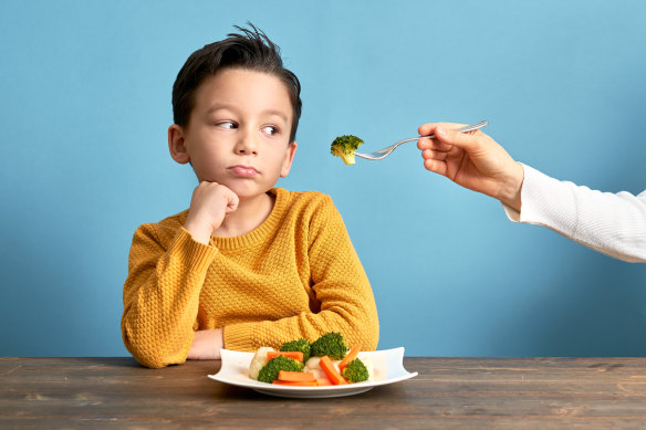 Child unhappy eating vegetables.