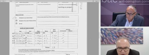Timesheets of an electoral officer are shown to Adem Somyurek during the IBAC hearing.